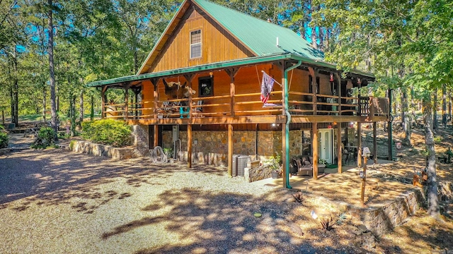 back of property with a patio area and a wooden deck