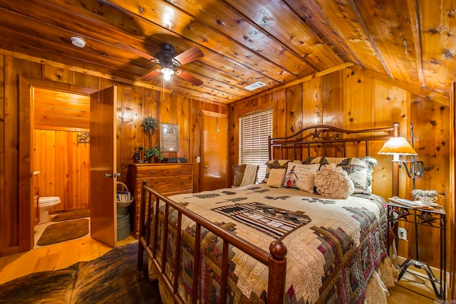 bedroom with wooden walls, vaulted ceiling, wood ceiling, and wood-type flooring