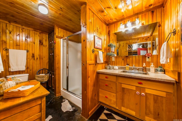 bathroom featuring vanity, wood walls, walk in shower, and toilet