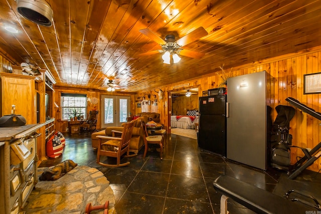 dining area with french doors, wood ceiling, and wooden walls