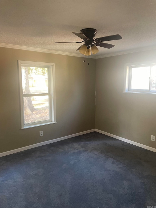 unfurnished room with ceiling fan, a textured ceiling, ornamental molding, and dark colored carpet