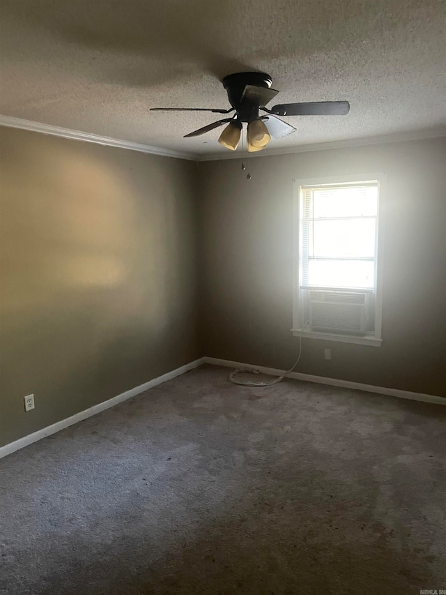 carpeted spare room featuring ceiling fan, a textured ceiling, and ornamental molding