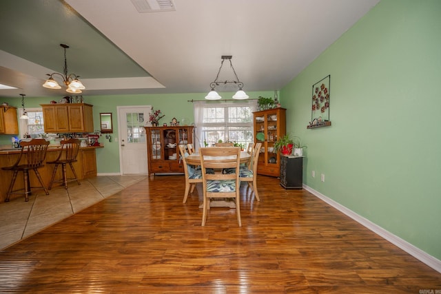 dining room featuring a chandelier and dark wood-type flooring