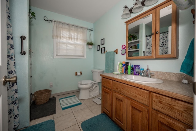 bathroom with vanity, toilet, and tile patterned floors