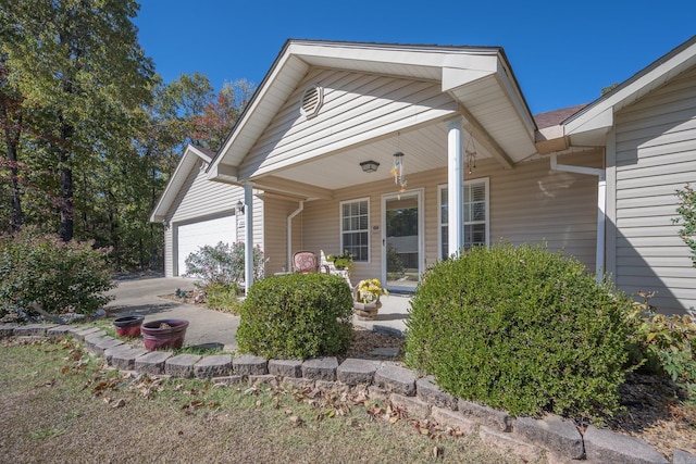 view of front of home with a porch and a garage