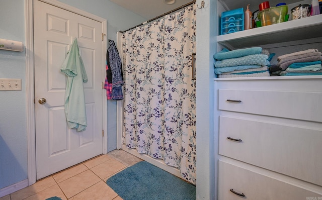 bathroom featuring tile patterned floors and a shower with curtain