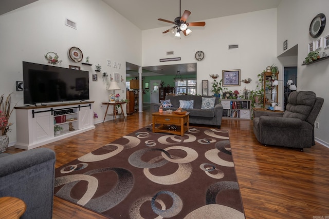 living room with dark hardwood / wood-style floors, high vaulted ceiling, and ceiling fan