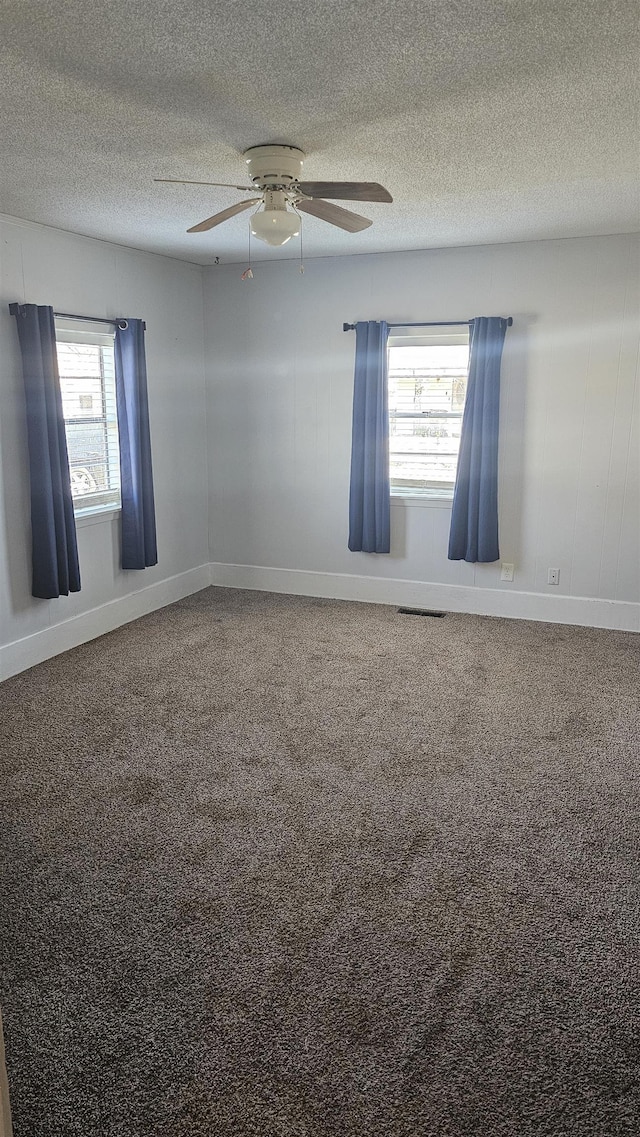 spare room with a textured ceiling and ceiling fan