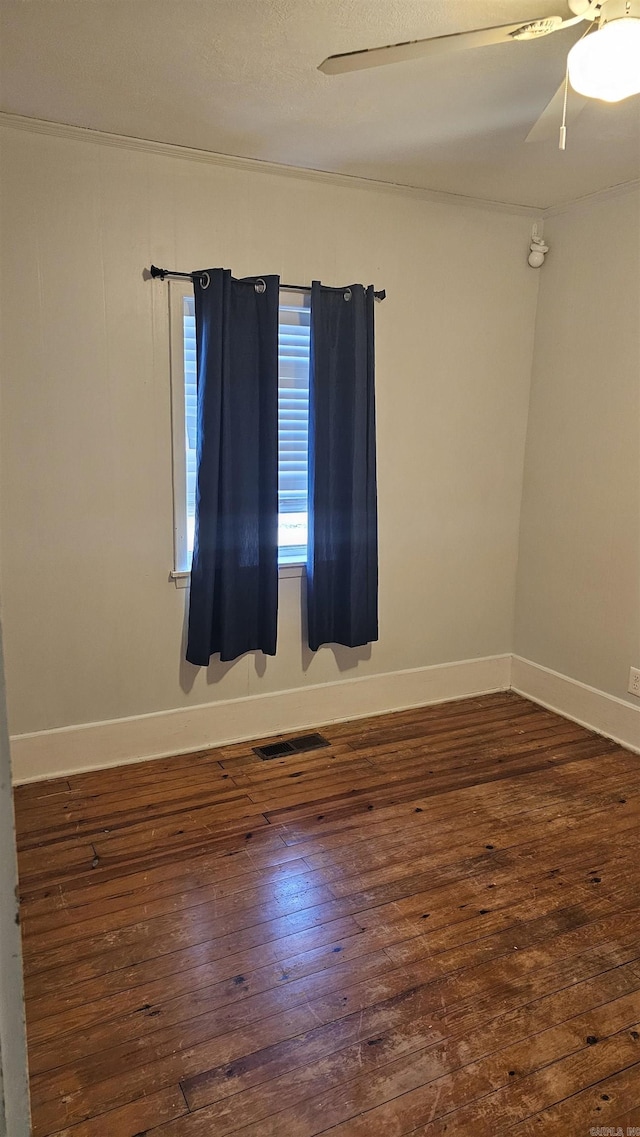 spare room featuring ceiling fan and dark hardwood / wood-style floors