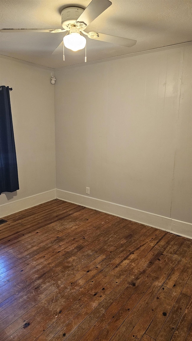 spare room featuring ceiling fan and dark hardwood / wood-style flooring