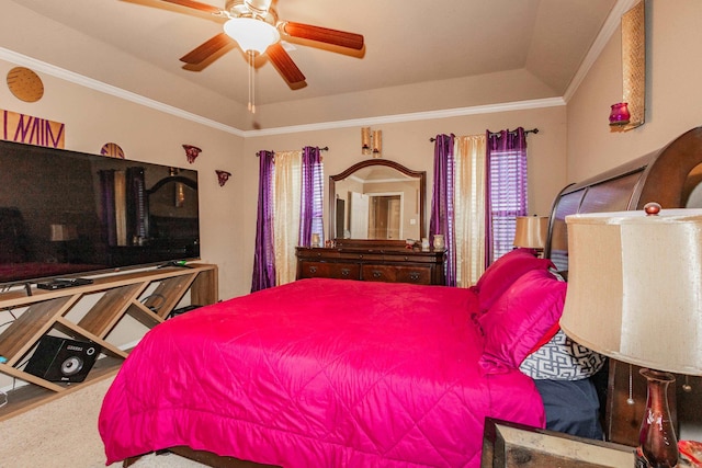 bedroom featuring lofted ceiling, ornamental molding, a tray ceiling, and ceiling fan