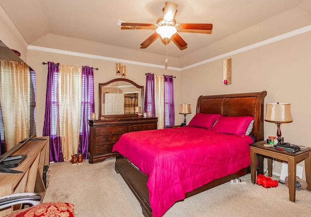 carpeted bedroom with crown molding, ceiling fan, and a raised ceiling