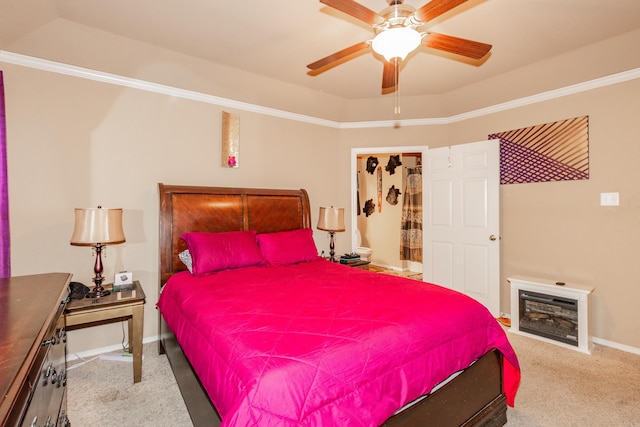 bedroom with ornamental molding, a raised ceiling, light carpet, and ceiling fan