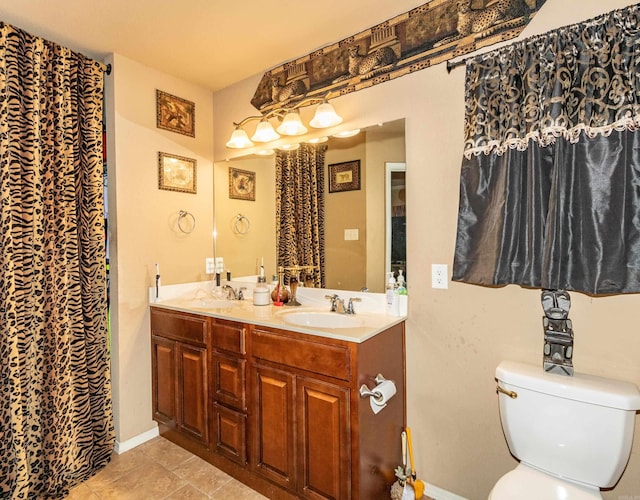 bathroom with vanity, toilet, and tile patterned floors