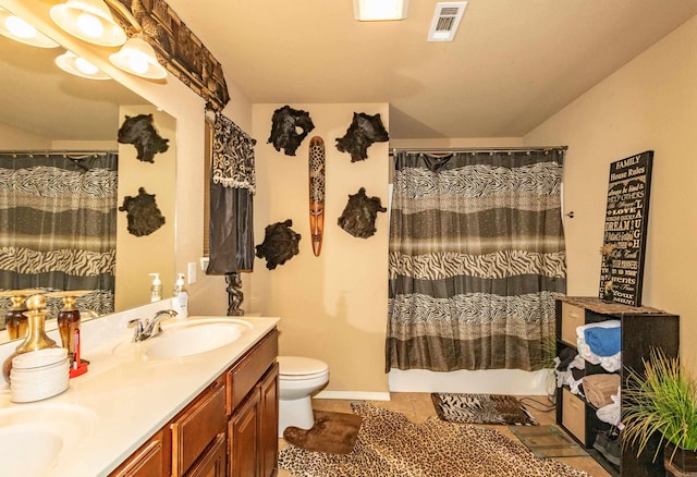 bathroom with toilet, curtained shower, vanity, and tile patterned floors