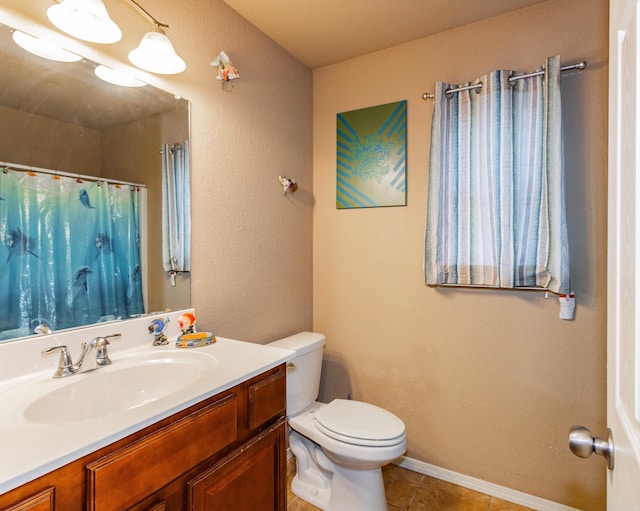 bathroom featuring vanity, toilet, and tile patterned floors