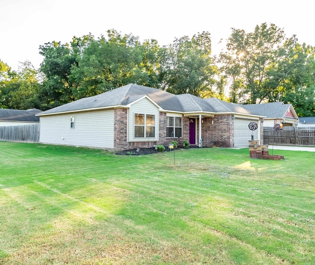 single story home featuring a front yard and a garage