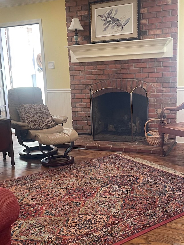 living room with a fireplace and wood-type flooring