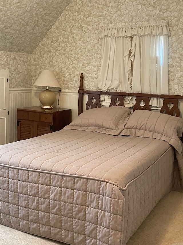 bedroom with carpet and lofted ceiling