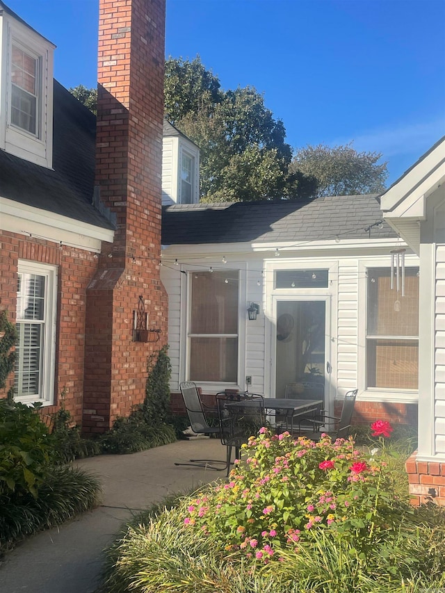 view of exterior entry featuring a patio