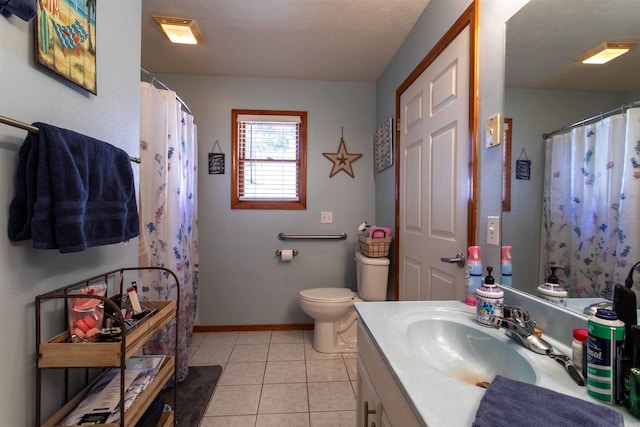 bathroom featuring tile patterned flooring, vanity, a textured ceiling, and toilet