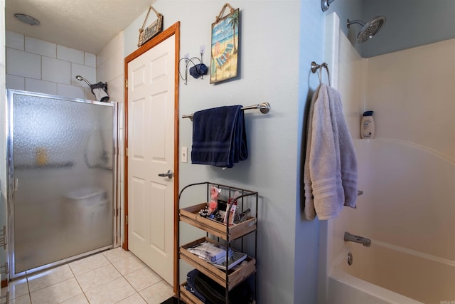 bathroom with a textured ceiling and tile patterned floors