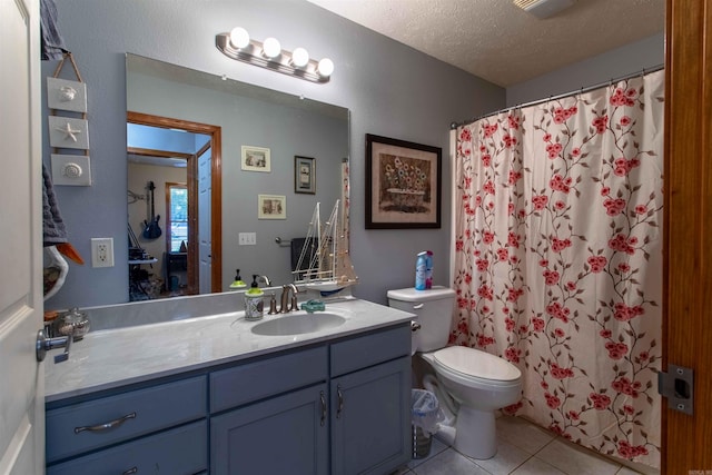 bathroom with vanity, a textured ceiling, a shower with shower curtain, tile patterned flooring, and toilet