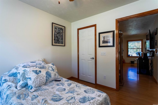 bedroom featuring wood-type flooring and a textured ceiling