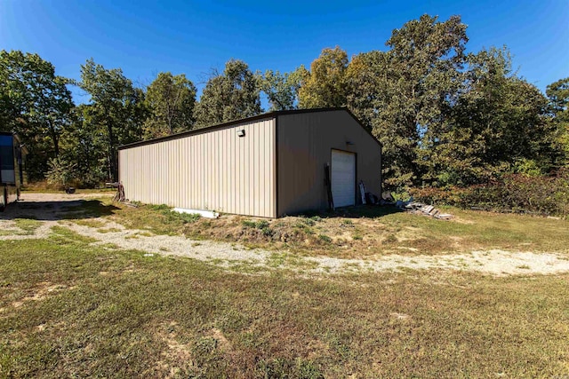 view of outbuilding featuring a lawn and a garage