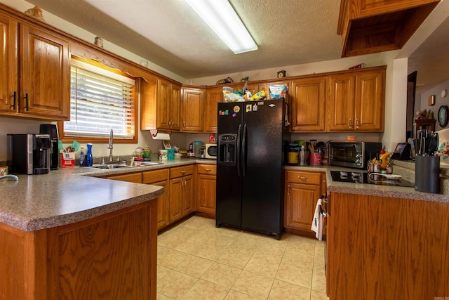 kitchen with a textured ceiling, sink, and black appliances