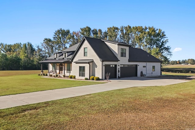 view of front of property featuring a front yard and a garage