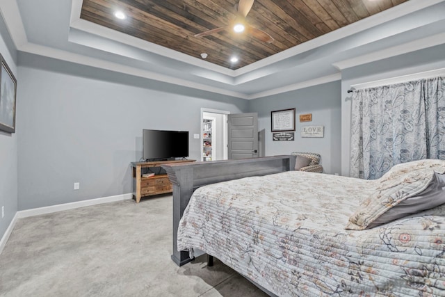 carpeted bedroom featuring ornamental molding, wood ceiling, and a tray ceiling