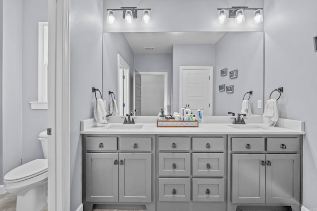 bathroom featuring vanity and toilet