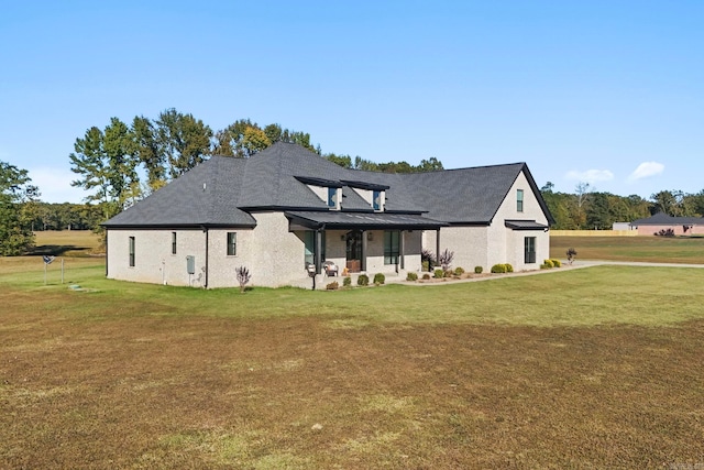 rear view of house with a yard