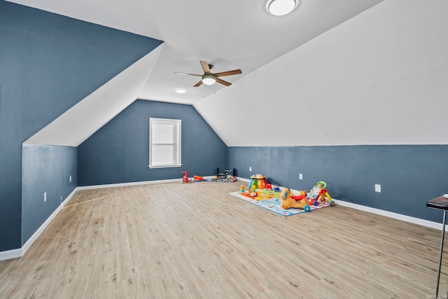 playroom featuring vaulted ceiling, light wood-type flooring, and ceiling fan