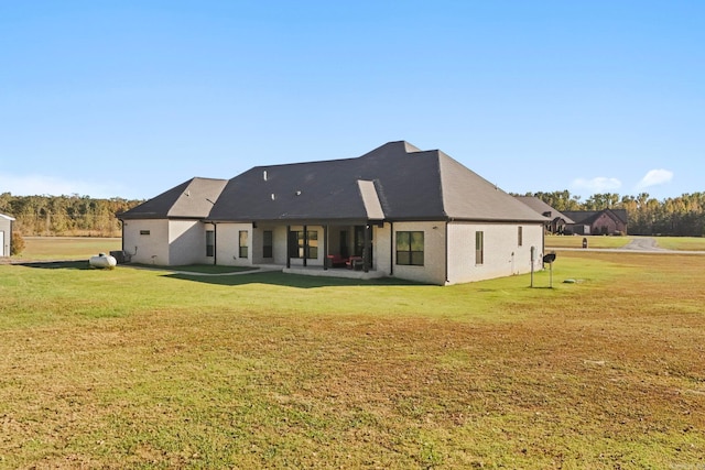 back of house featuring a yard and a patio area