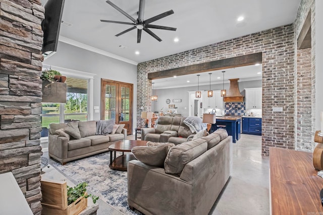 living room with french doors, crown molding, and ceiling fan