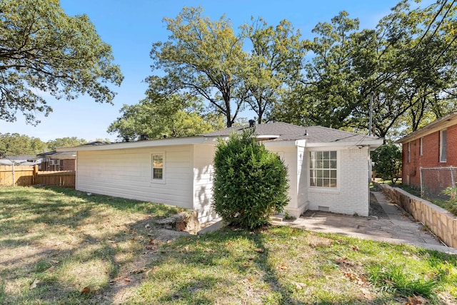 rear view of house with a yard