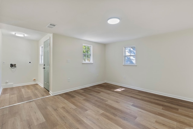 unfurnished room with light hardwood / wood-style flooring