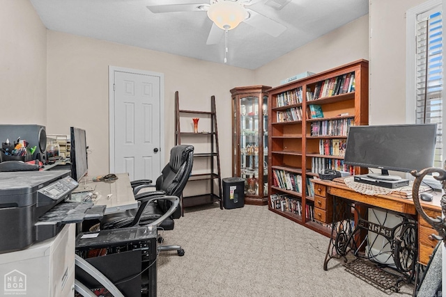 carpeted office featuring ceiling fan