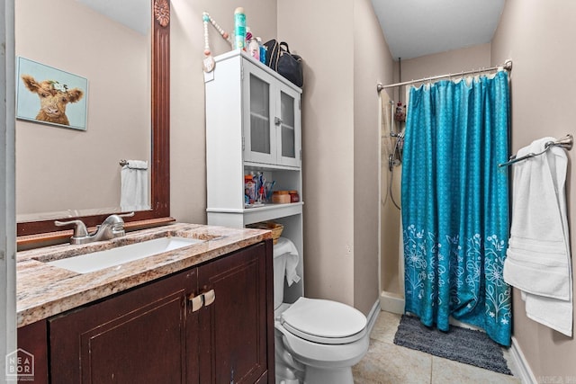 bathroom featuring tile patterned floors, toilet, vanity, and walk in shower