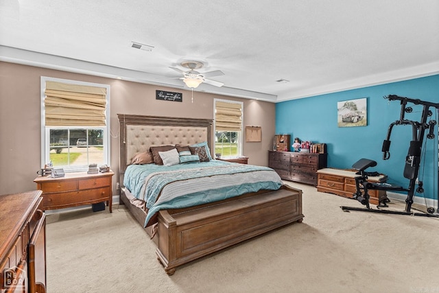 carpeted bedroom with ceiling fan and a textured ceiling