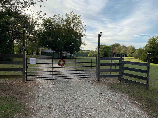 view of gate with a yard