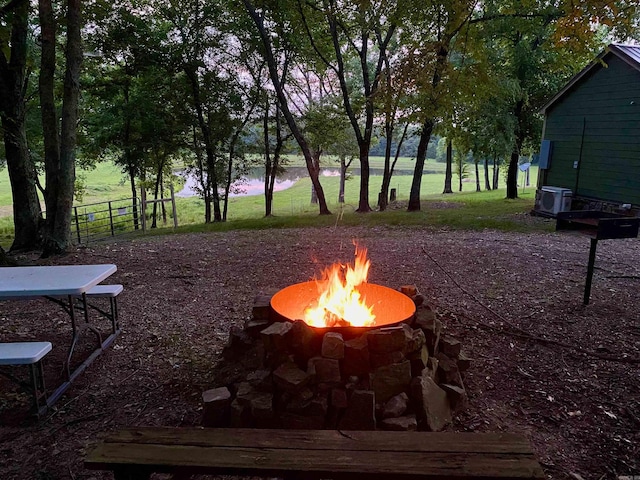 view of yard with cooling unit and a fire pit