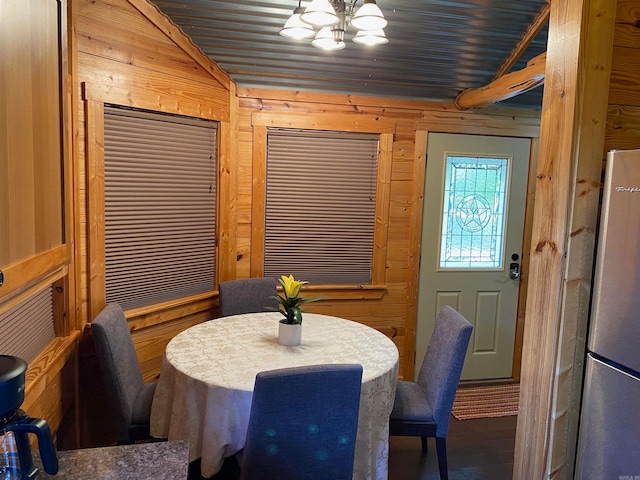 dining space featuring wooden walls