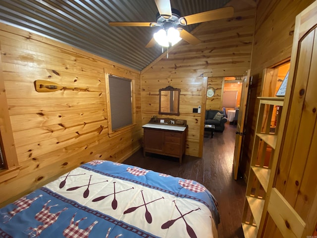 bedroom with wooden walls, vaulted ceiling, dark hardwood / wood-style floors, and ceiling fan