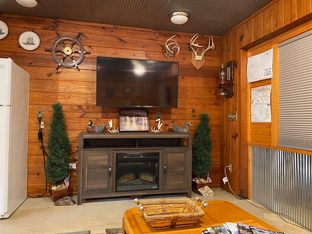 living room featuring light carpet and wood walls