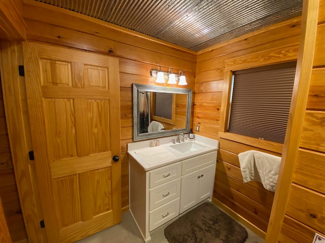 bathroom featuring vanity and wooden walls