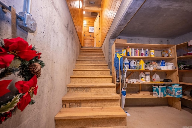 staircase with concrete flooring