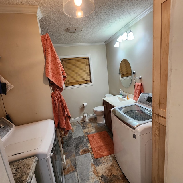 bathroom with sink, washer and dryer, ornamental molding, and a textured ceiling